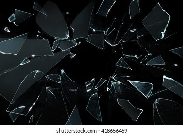 Shattered and broken glass pieces isolated on black - Shutterstock ID 418656469