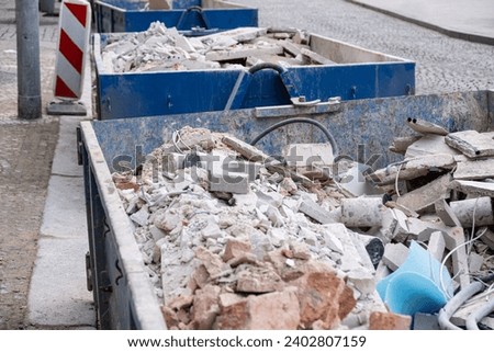Shattered, broken wall bricks, construction waste after building demolition,in a construction waste container. A collection service is available to handle the disposal of these materials.