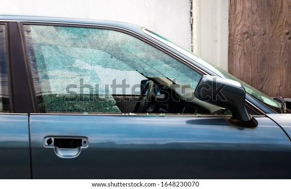 Shattered car\
window. Car break in. Passenger window is smashed in pieces from a\
thief or vandalized. Large hole. \
