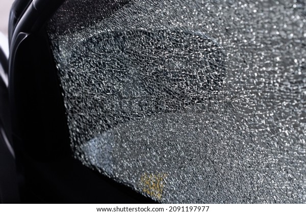 Shattered glass car wind screen\
that break by the car theft on day time. Car thief, car theft\
concept