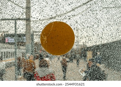 Shattered glass with yellow marker against urban background, blurred figures and architecture create dynamic atmosphere - Powered by Shutterstock