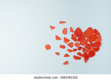 Shattered Heart Made Of Glass Pieces On A Light Blue Background. Love Minimal Concept