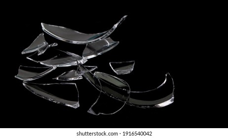 Shattered Wine Glass Shards Isolated On Black Background. 