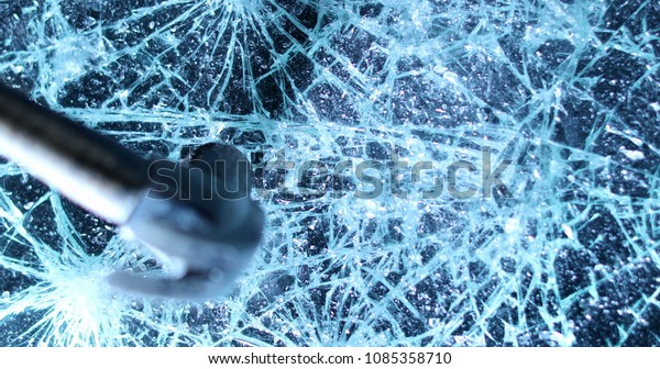 Shattering glass screen with\
hammer