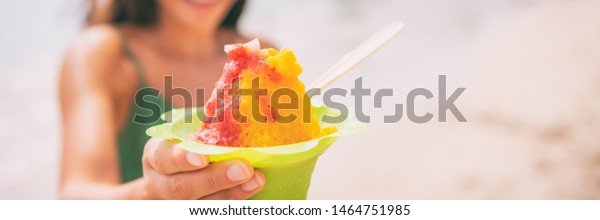 Shave Ice Hawaiian food dessert woman\
eating frozen treat panoramic banner\
background.