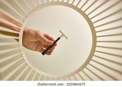 The shaver is disposed of and recycled in the trash. View from below. The concept of disposal and recycling of waste. - Shutterstock ID 2255865673