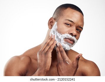 Shaving Can Give You A Whole New Look. Studio Portrait Of A Handsome Young Man Applying Shaving Cream To His Face Against A White Background.