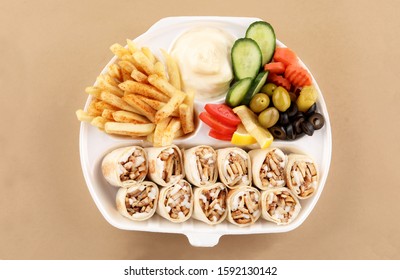 shawarma meal two tortilla sandwich with appetizer and fried potato in shawarma box top view