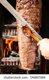 Shawarma meat being cut before making a sandwich