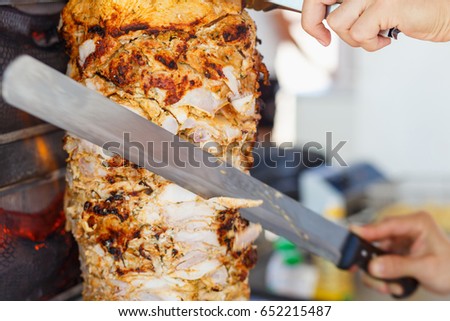Shawarma meat being cut before making a sandwich