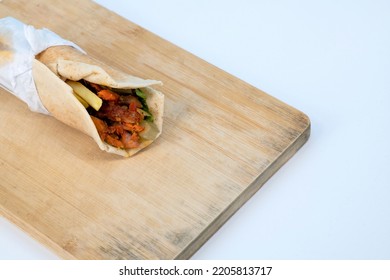 Shawarma Sandwich - Fresh Roll Of Thin Lavash (pita Bread) Filled With Grilled Chicken, Cabbage, Carrots, Sauce, Green. Traditional Eastern Snack. Shawarma Rool On Isolated White Background. 