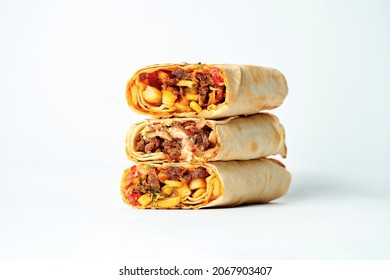 Shawarma stacked one on top of the other with meat and vegetable filling. A stack of shawarma on a white background. Selective focus