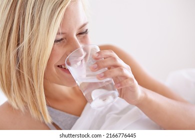 She Always Drinks A Glass Of Water Before Bed. A Young Woman Drinking A Glass Of Water Before Bed.