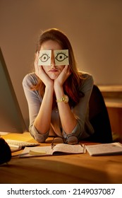 She Cant Keep Her Eyes Open. Portrait Of An Attractive Young Businesswoman Sitting With Sticky Notes Over Her Eyes In The Office.