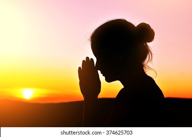 She Folded Her Hands In Prayer. Beautiful Sunset.