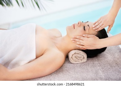 She Has The Magic Touch. A Young Woman Getting A Face Massage From A Massage Therapist.