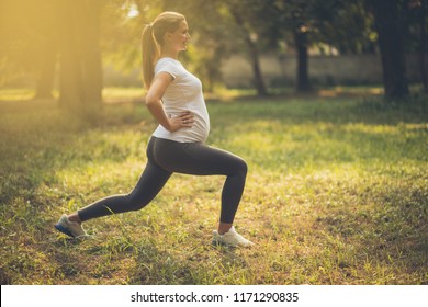 She Has Reached The Goals Of Pregnancy Fitness. Pregnant Woman Working Exercise In Nature. 