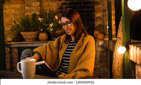 She Likes To Read Book In Her Backyard. Night Scene