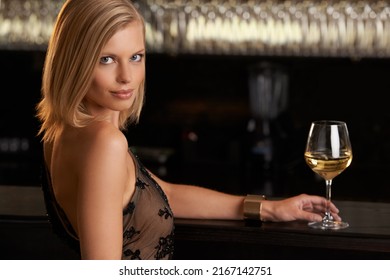 She Lives The High Life. An Attractive And Classy Young Woman Standing At The Bar Of A Upper Class Establishment.