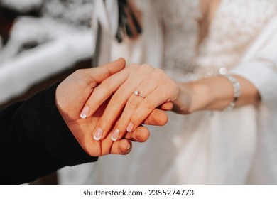 She said yes, concept of an expensive gold diamond ring on a woman's hand, held by her fiance. Man holding woman's hand with ring close-up, women's jewelry shot idea photo. - Powered by Shutterstock