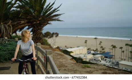 She Stops To Take In The Pacific Ocean On Her Bike Home From Work In Santa Monica, California. 