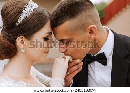 She told him yes. A young man kisses his wife's hand with a gold ring, proposing marriage. Engagement of a young couple in love. Concept of love and unity.