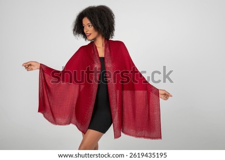 She unfurls ruby wings of shimmer, floating in effortless grace; sparkles trace the edges, midnight dress anchors the glow, as she commands the quiet studio with poised, radiant confidence tonight.!!!