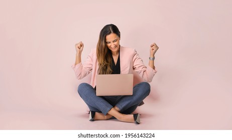 She Is A Winner! Excited Young Female With Laptop Isolated On Pi