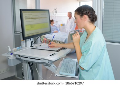 she is writing the patients details - Powered by Shutterstock