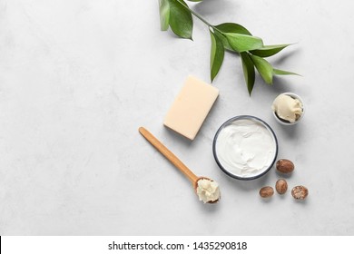 Shea butter with cream and soap on light background