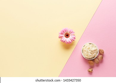 Shea Butter With Nuts And Flower On Color Background