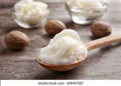 Shea butter in spoon and bowls on wooden background, close up - Shutterstock ID 639497587