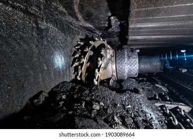 Shearer drill head in a coal mine. Extraction of coal by underground method.