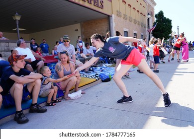 Sheboygan, Wisconsin / USA - July 4th, 2020: Girl Of Pink Heals Breast Cancer Awareness Group Hands Out Ice Pops To Kids That Spectate Freedom Pride Parade On Independence Day Of The USA.  