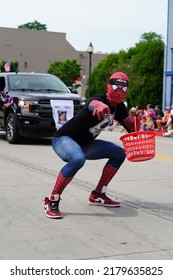 Sheboygan, Wisconsin USA - July 4th, 2022: Freedom Fest Parade Participates Dressed Up In Spider Man Costume And Interacted With Spectators.