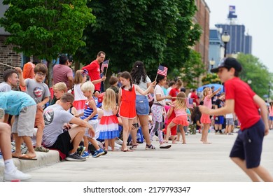 Sheboygan, Wisconsin USA - July 4th, 2022: Spectators Waving American Flags During Freedom Fest Parade.