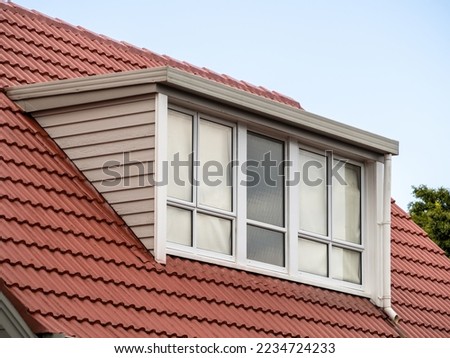 Shed dormer loft with glass wall on red tiled roof. ストックフォト © 