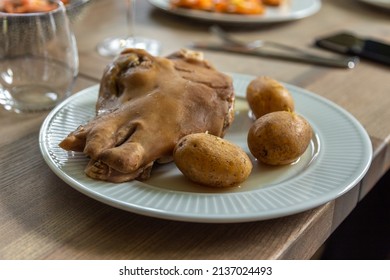 A Sheep Head With Boiled Potatoes, A Traditional Faroese Dish. White Plate On Wooden Table. Soldafjordur, Faroe Islands.