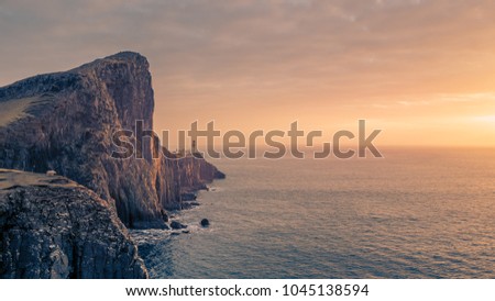 Sheep watching the sunset at the Neist Point lighthouse on Sky Island in Scotland.