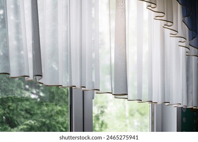 Sheer curtains casting wavy shadows, sunlit window overlooking green trees. Light diffusion through soft white drapery, tranquil home decor. - Powered by Shutterstock