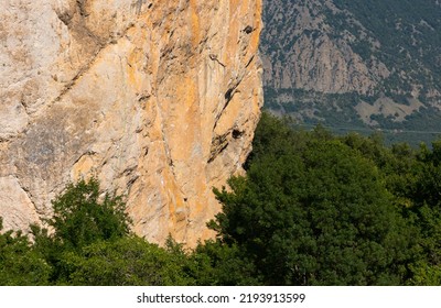 A Sheer Wall Of Red-gray Color On A Rock In The Mountains, The Texture Of Natural Stone. Active Sport.