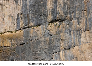 A Sheer Wall Of Red-gray Color On A Rock In The Mountains, The Texture Of Natural Stone. Active Sport. Selective Focus