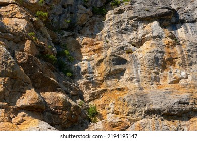 A Sheer Wall Of Red-gray Color On A Rock In The Mountains, The Texture Of Natural Stone. Active Sport. Background, Stone Texture. Soft Focus