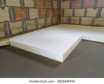 Sheet of expanded polystyrene on the concrete floor for house thermal insulation during constructions