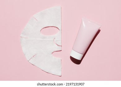 Sheet facial mask with cosmetic product on a pink background. Fabric face mask, face cream. Facial skin care at home. - Powered by Shutterstock