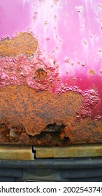 Sheet Metal Corrosion With Hole Of Old Car. Rusty Surface, Background And Damaged Texture From Road Salt. Remove Steel Rust From Vehicle. Protection And Painting Auto Concept. Fix Rusted Truck Bed.