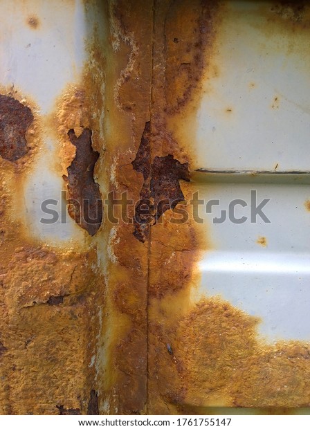 Sheet metal corrosion of\
an old steel equipment. Rusty surface, background and damaged\
texture. 