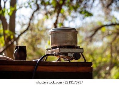 Sheet Metal Pot On A Stove Connected To A Bottled Gas Cylinder