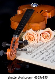 Sheet music of the Wedding March, with roses and violin