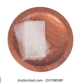 Sheets Of Colourless Gelatin Aka Gelatine Leaves On A Wooden Plate Isolated On White. Food Ingredient.